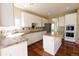 Modern kitchen featuring white cabinets, granite countertops, and stainless steel appliances at 18112 E Dorado Ave, Centennial, CO 80015