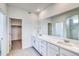 Modern bathroom with double vanity, quartz countertop, and walk-in shower with marble tile at 680 Tubman Dr, Elizabeth, CO 80107