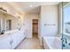 Contemporary bathroom with a soaking tub, dual sinks and a walk-in closet at 680 Tubman Dr, Elizabeth, CO 80107