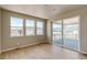 Bright bedroom featuring wood floors, large windows offering natural light, and access to an outdoor deck at 680 Tubman Dr, Elizabeth, CO 80107
