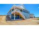 Rear exterior of home with elevated deck and walkout basement; still under construction and landscaping at 680 Tubman Dr, Elizabeth, CO 80107