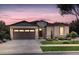 Charming one-story home with stone accents, a two-car garage, and beautiful landscaping at 680 Tubman Dr, Elizabeth, CO 80107