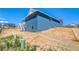 Exterior home view with composite siding, showcasing a walkout basement and deck with stairs at 680 Tubman Dr, Elizabeth, CO 80107