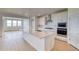 Bright kitchen features a large island, white cabinets, stainless steel appliances, and hardwood floors at 680 Tubman Dr, Elizabeth, CO 80107