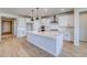 Spacious kitchen featuring a center island with stone countertop and modern light fixtures at 680 Tubman Dr, Elizabeth, CO 80107
