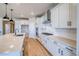 Bright kitchen with white cabinets, stone countertops, and stainless steel appliances at 680 Tubman Dr, Elizabeth, CO 80107