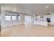 Spacious living area with hardwood floors, large windows, and open layout to the kitchen at 680 Tubman Dr, Elizabeth, CO 80107