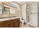 Bathroom featuring a walk-in shower and a vanity with ample lighting at 1431 S Chambers Cir, Aurora, CO 80012