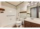 Bathroom with combination tub and shower, wooden grab bars and updated sink at 1431 S Chambers Cir, Aurora, CO 80012