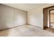 Bedroom with paneled wall and door leading to room with stone-look flooring at 1431 S Chambers Cir, Aurora, CO 80012