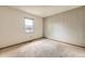 Bedroom featuring vertical paneling on one wall and a window providing natural light at 1431 S Chambers Cir, Aurora, CO 80012