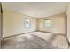 Sunlit bedroom with neutral carpeting and a view from the window at 1431 S Chambers Cir, Aurora, CO 80012