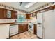 Bright kitchen with wooden cabinets, updated appliances, and a cozy breakfast nook at 1431 S Chambers Cir, Aurora, CO 80012