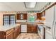 Well-lit kitchen features wooden cabinets, bright countertops, and standard white appliances at 1431 S Chambers Cir, Aurora, CO 80012