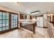 The kitchen features an island with white countertop and double doors to a sunroom at 1431 S Chambers Cir, Aurora, CO 80012