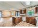 Warm kitchen with a view of the dining space featuring wood cabinets and white appliances at 1431 S Chambers Cir, Aurora, CO 80012