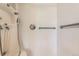 Close-up of shower with white tiled walls and chrome fixtures at 1431 S Chambers Cir, Aurora, CO 80012
