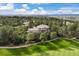 Aerial view of an estate located on a lush green golf course and a dense forest at 145 Capulin Pl, Castle Rock, CO 80108