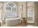 Bright bathroom featuring a soaking tub, large window and a glass enclosed shower at 145 Capulin Pl, Castle Rock, CO 80108