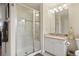 Well-lit bathroom with a glass shower, granite countertop, and modern vanity at 145 Capulin Pl, Castle Rock, CO 80108