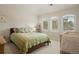 Neutral bedroom with arched windows, plush carpet, and a wooden crib at 145 Capulin Pl, Castle Rock, CO 80108