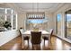 Charming dining nook with natural light, a modern chandelier, and sliding door access to a balcony at 145 Capulin Pl, Castle Rock, CO 80108