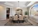 Formal dining area featuring a tray ceiling, modern lighting fixture, and large windows at 145 Capulin Pl, Castle Rock, CO 80108