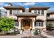 Inviting front entrance with an arched doorway, stone pathway, and manicured landscaping at 145 Capulin Pl, Castle Rock, CO 80108