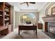 Home office with a fireplace, large window, and desk with lots of natural light at 145 Capulin Pl, Castle Rock, CO 80108