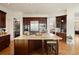 Spacious kitchen with stainless appliances, dark cabinets and large island with bar seating at 145 Capulin Pl, Castle Rock, CO 80108