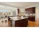 Spacious kitchen features dark wood cabinets, granite counters, and a large island with a cooktop at 145 Capulin Pl, Castle Rock, CO 80108