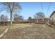 This wide shot shows a big backyard with a view of the house and garage at 5669 Johnson Ct, Arvada, CO 80002