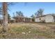 View of a backyard showing a brick house, garage and the lawn at 5669 Johnson Ct, Arvada, CO 80002