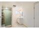 Bright bathroom featuring a shower, vanity, modern lighting and white walls at 5669 Johnson Ct, Arvada, CO 80002