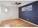 Bright bedroom features hardwood floors, a modern ceiling fan, and a blue accent wall for a cozy atmosphere at 5669 Johnson Ct, Arvada, CO 80002