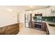 Modern kitchen with stainless steel appliances, stylish cabinets, and subway tile backsplash at 5669 Johnson Ct, Arvada, CO 80002