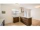 Well-lit kitchen with custom island, modern cabinets, and tile flooring at 5669 Johnson Ct, Arvada, CO 80002