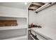 A storage room with shelves, a workbench, and pegboard for organization at 5669 Johnson Ct, Arvada, CO 80002