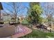 Outdoor living space featuring a stone patio with dining and seating areas, plus mature trees at 4236 Frederick Cir, Longmont, CO 80503