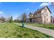 Spacious backyard with lush lawn, walking path, and views of the home's exterior at 4236 Frederick Cir, Longmont, CO 80503
