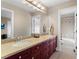Bathroom with granite counters, double sinks, and tile flooring at 4236 Frederick Cir, Longmont, CO 80503