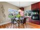 Bright dining area with large windows, wood floors, and custom wall art at 4236 Frederick Cir, Longmont, CO 80503