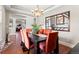 Bright dining room with coffered ceiling, orange chairs, and view to living room at 4236 Frederick Cir, Longmont, CO 80503