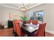 Bright dining room with coffered ceiling, orange chairs, and large window for natural light at 4236 Frederick Cir, Longmont, CO 80503