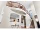 Spacious foyer with curved staircase and high ceilings, offering a grand entrance to the home at 4236 Frederick Cir, Longmont, CO 80503