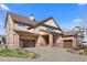 Charming two-story home featuring a three-car garage, stone accents, and a covered front porch at 4236 Frederick Cir, Longmont, CO 80503