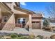 Inviting home with a stone-accented porch and a well-manicured lawn with colorful landscaping at 4236 Frederick Cir, Longmont, CO 80503