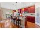Open kitchen with dark wood cabinets, granite countertops, a breakfast bar, and stainless steel appliances at 4236 Frederick Cir, Longmont, CO 80503