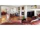Cozy living room featuring a fireplace, built-in shelving, and hardwood flooring at 4236 Frederick Cir, Longmont, CO 80503