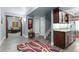 Open living room with a bar area, built-in cabinets, and hardwood-style floors at 4236 Frederick Cir, Longmont, CO 80503